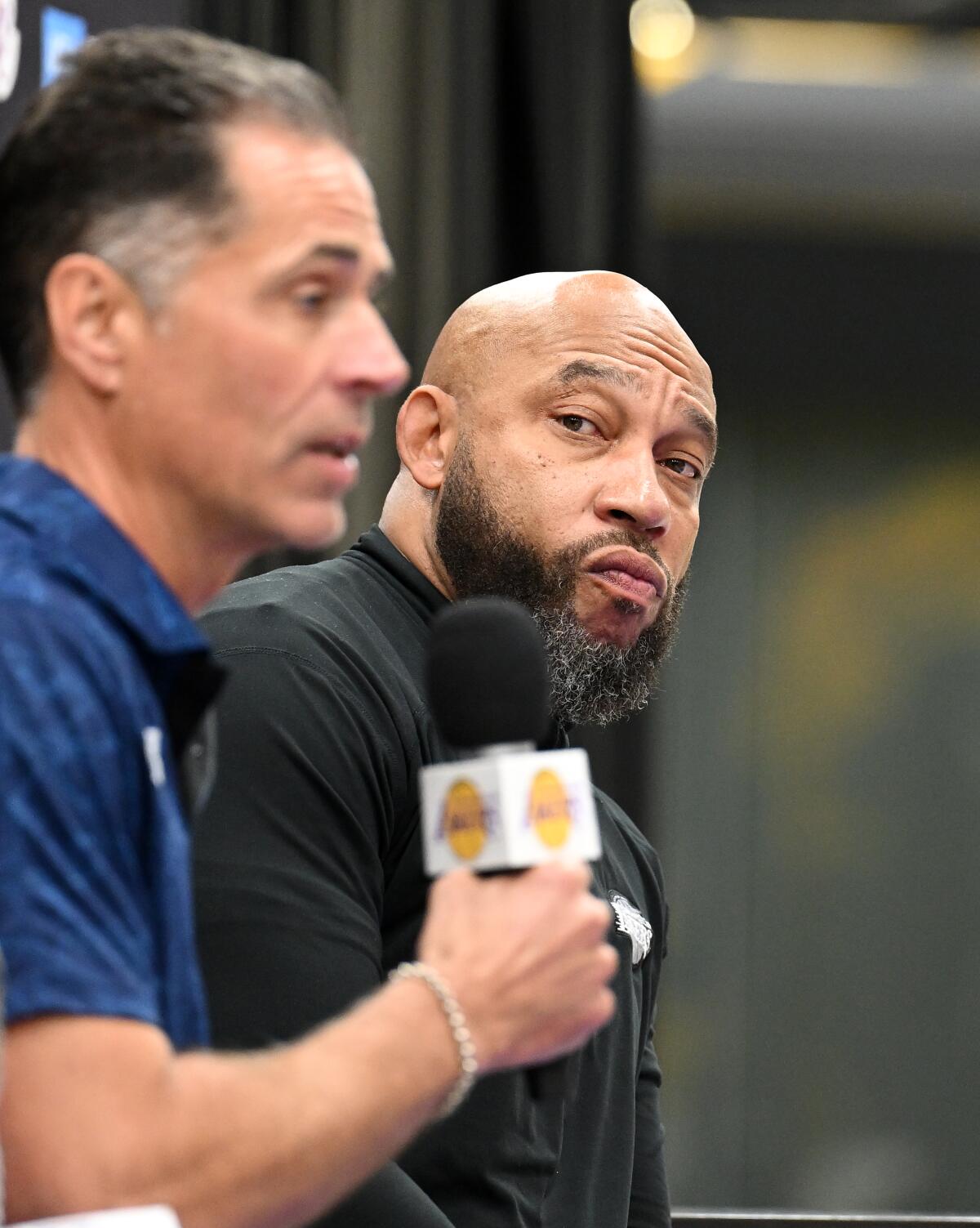 Lakers general manager Rob Pelinka, left, speaks while sitting next to Lakers coach Darvin Ham during a news conference.