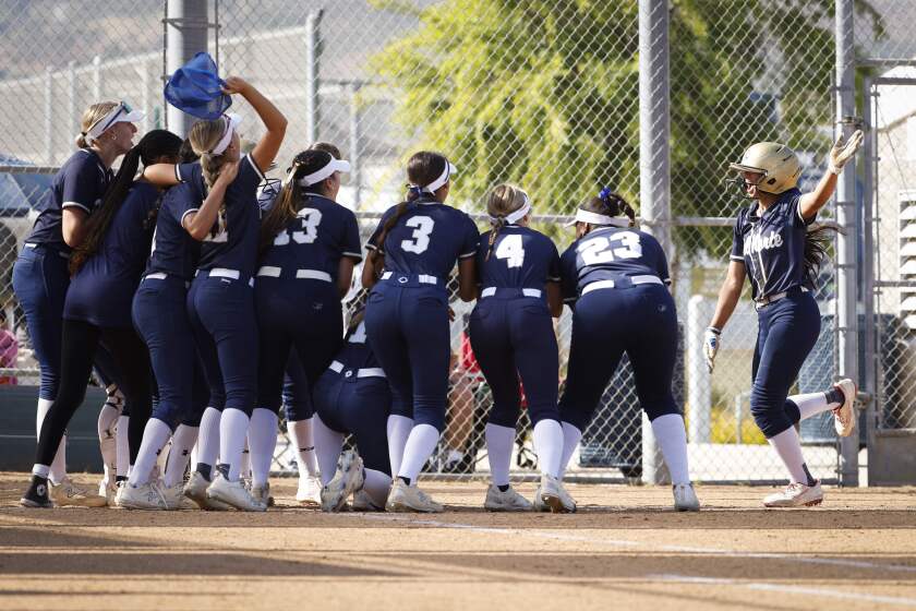 San Diego, CA - May 21: Del Norte players celebrate Lainey Llamas (9) home run against Mater Dei Catholic during the CIF San Diego Section Open Division softball semifinal game at Del Norte High School on Tuesday, May 21, 2024 in San Diego, CA. (Meg McLaughlin / The San Diego Union-Tribune)