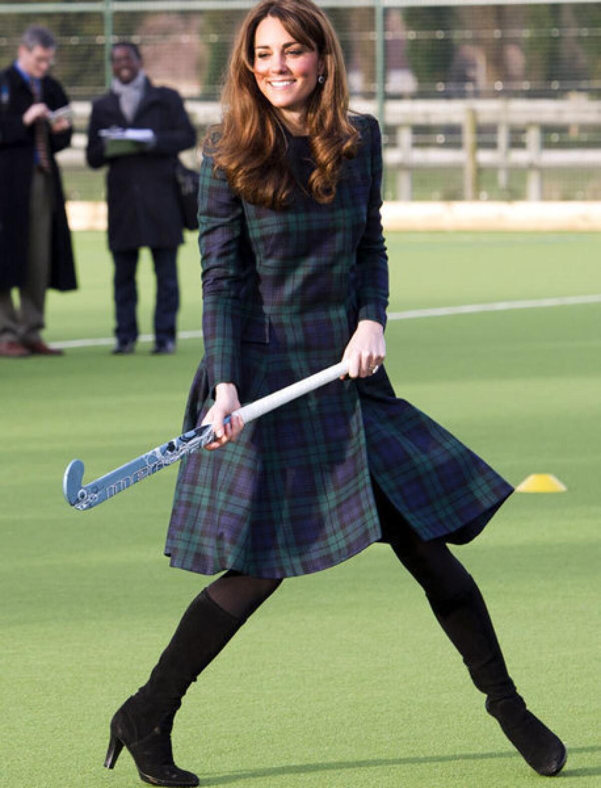 Catherine, Duchess of Cambridge, playing hockey with students Friday during her visit to St Andrew's School in Pangbourne, Berkshire, England.