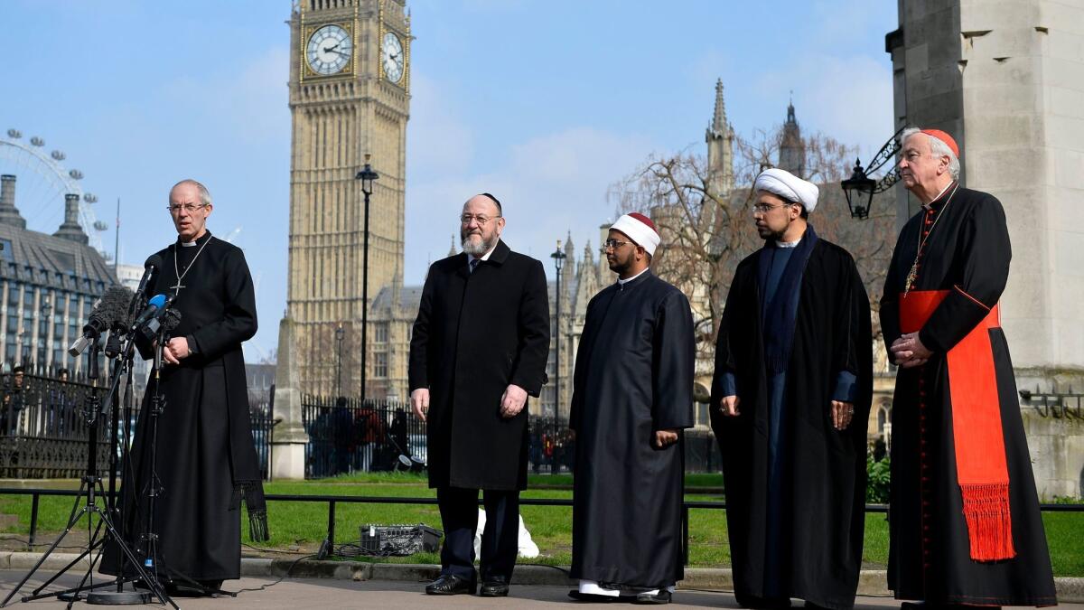 Britain's Archbishop of Canterbury Justin Welby speaks as inter-faith leaders listen during a vigil on the grounds of Westminster Abbey in London with Big Ben and the Houses of Parliament in the background on March 24, 2017. (Hannah McKay / EPA)