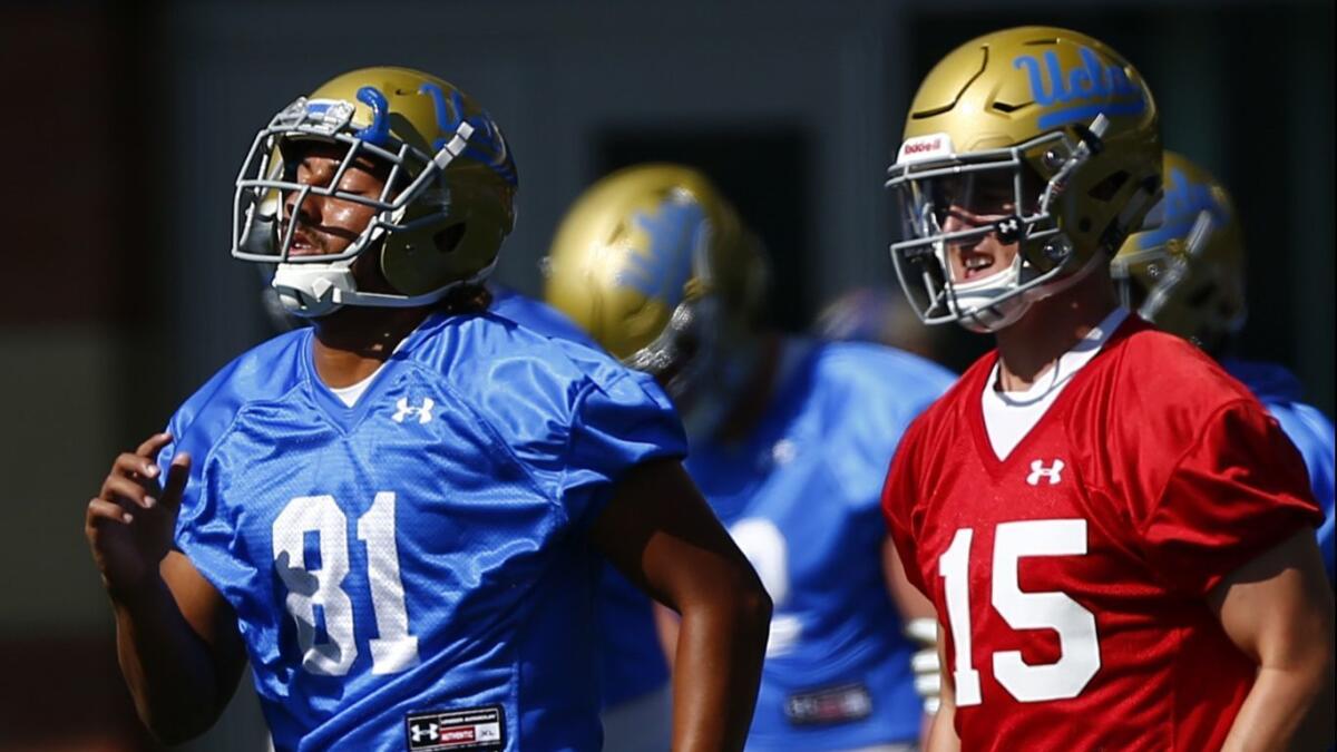 UCLA tight end Caleb Wilson, left, and quarterback Matt Lynch go through drills during the first day of practice.
