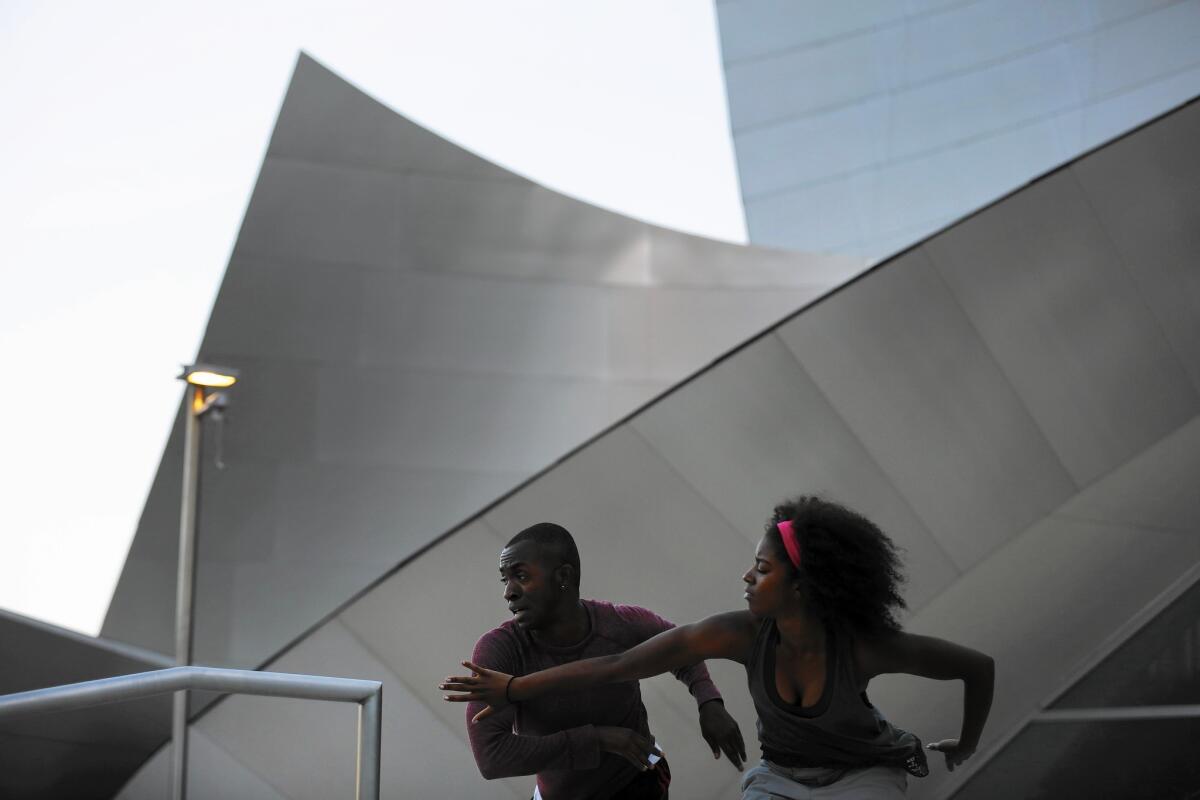Bernard Brown, 35, of Los Angeles and Tehran Dixon, 26, of Panorama City from the Lula Washington Dance Theatre rehearse for the Music Center's "Moves After Dark" program on the steps of the Walt Disney Concert Hall in Los Angeles.