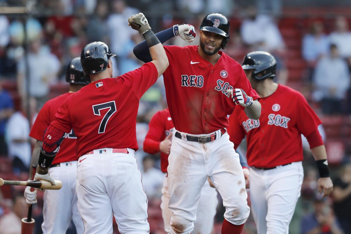Xander Bogaerts, front right, celebrates his three-run homer with Christian Vazquez (7) 