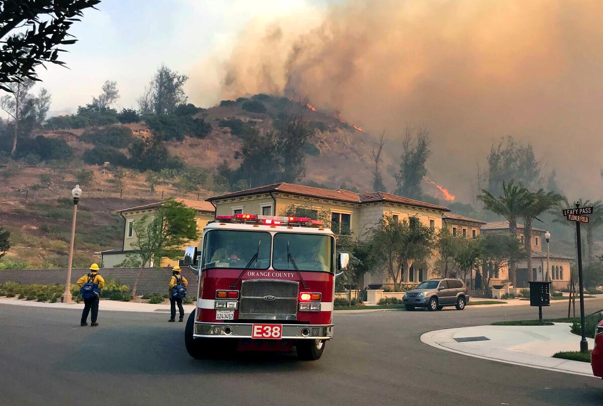 Firefighters protect an Irvine neighborhood