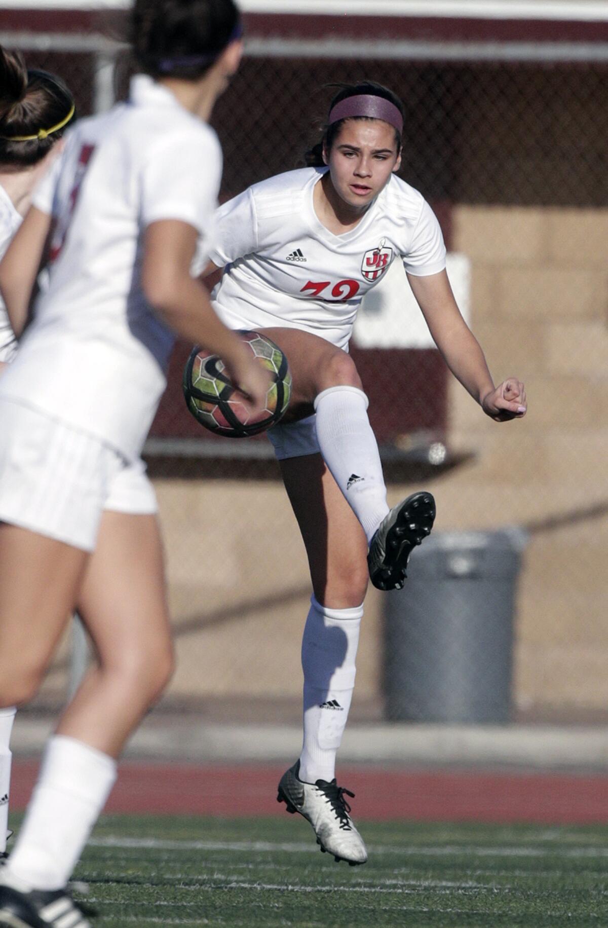 Burroughs' Jesse Virtue attempts to clear the ball against an Arcadia attack in a Pacific League girls' soccer game at Arcadia High School in Arcadia on Tuesday, January 28, 2020.