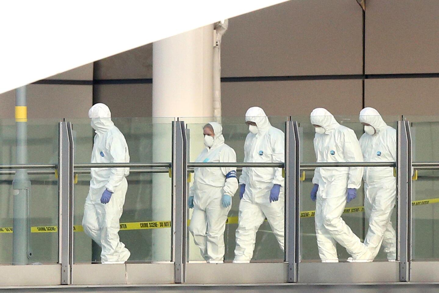 Forensic officers work the scene at Manchester Arena on Tuesday.