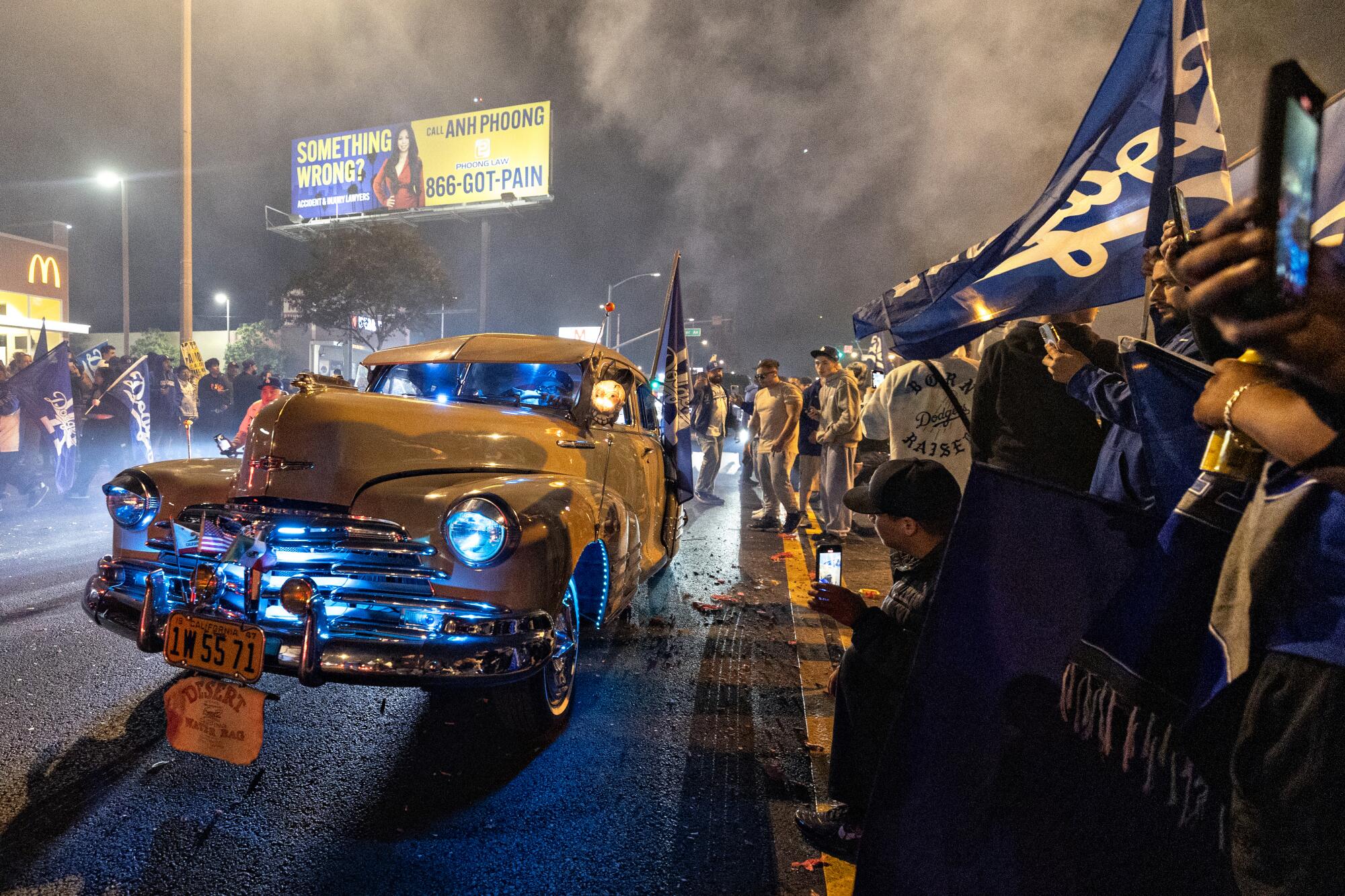 Ain't no occasion like an East L.A. Dodgers occasion — and it did not cease 5 A vintage car on a street lined with Dodgers fans