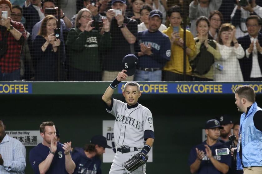 Seattle Mariners right fielder Ichiro Suzuki waves to spectators while leaving the field for defensive substitution in the eighth inning of Game 2 of the Major League baseball opening series against the Oakland Athletics at Tokyo Dome in Tokyo, Thursday, March 21, 2019. (AP Photo/Koji Sasahara)