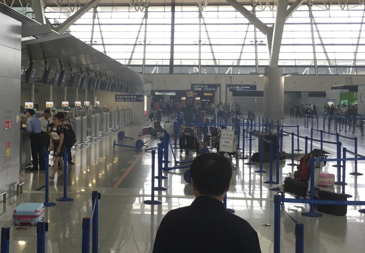 In this photo released by Bowen Ni, luggage and barriers are scattered in the aftermath of an explosion at Shanghai's Pudong airport Sunday.