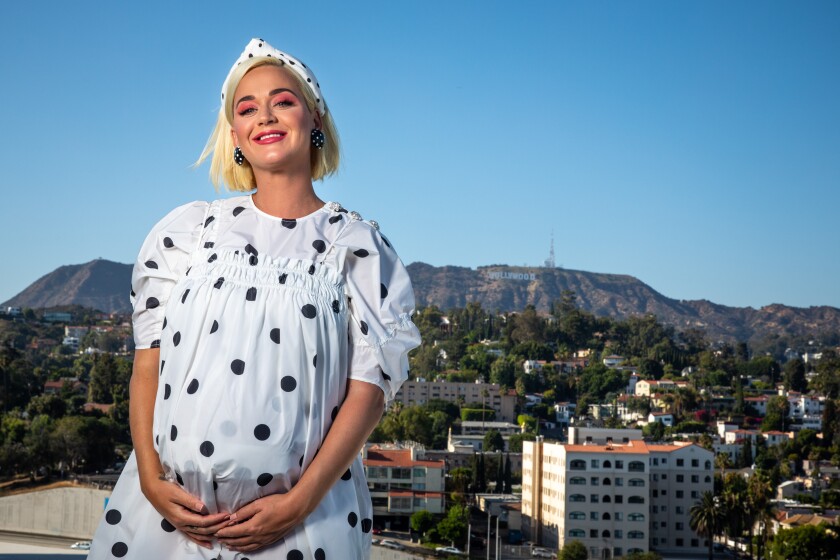 Katy Perry stands on the roof of Capitol Records.