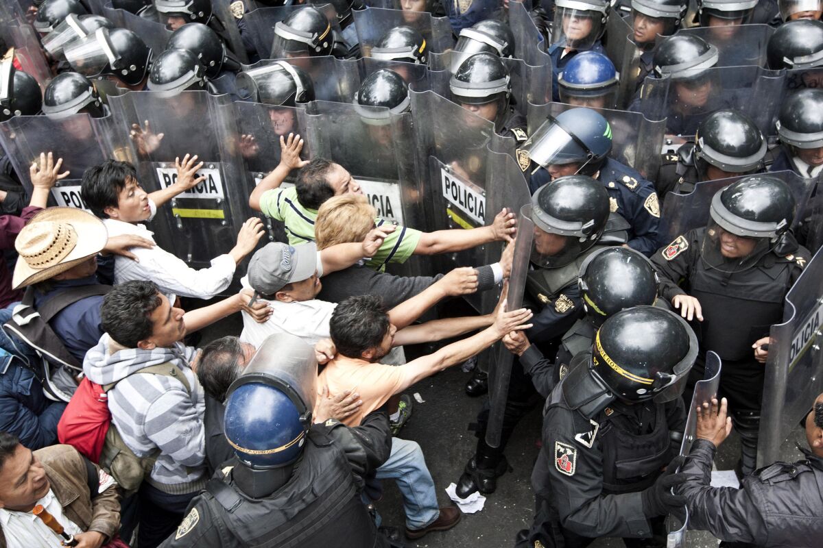 Last September, striking teachers protesting education reforms tried to get past a wall of riot police in Mexico City. A new "report card" on the unionized educators says that 70 are paid more than the president.