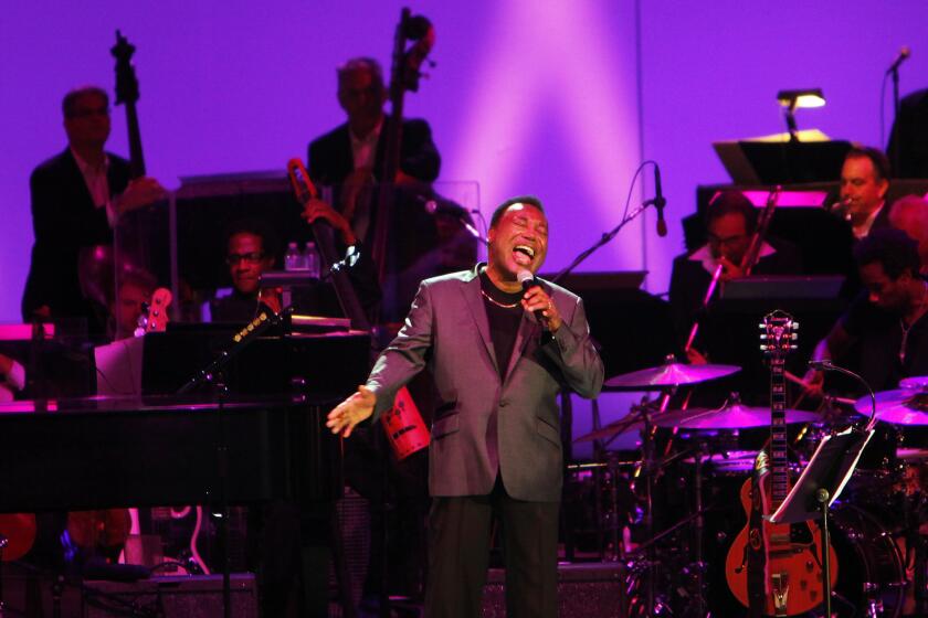 George Benson sings during a concert paying tribute to Nat King Cole at the Hollywood Bowl on Wednesday night. (Michael Robinson Chavez/Los Angeles Times)