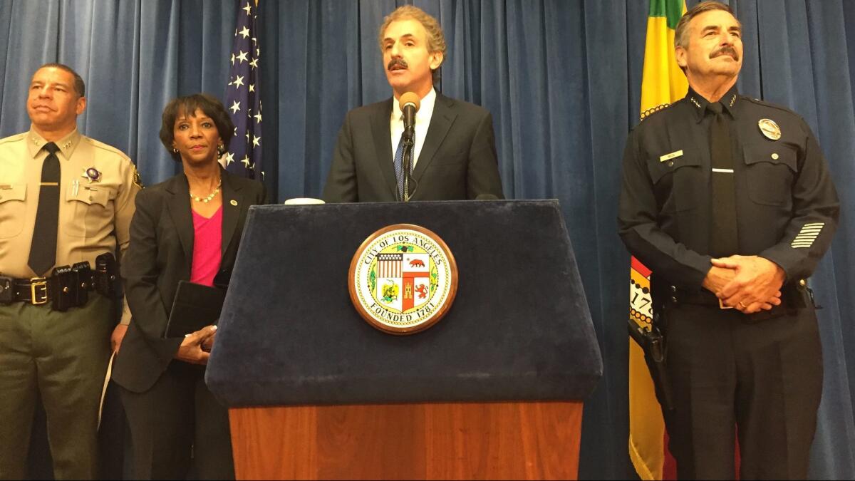 Los Angeles Dist. Atty. Jackie Lacey, City Atty. Mike Feuer, center, and LAPD Chief Charlie Beck speak about an increase in hate crimes.