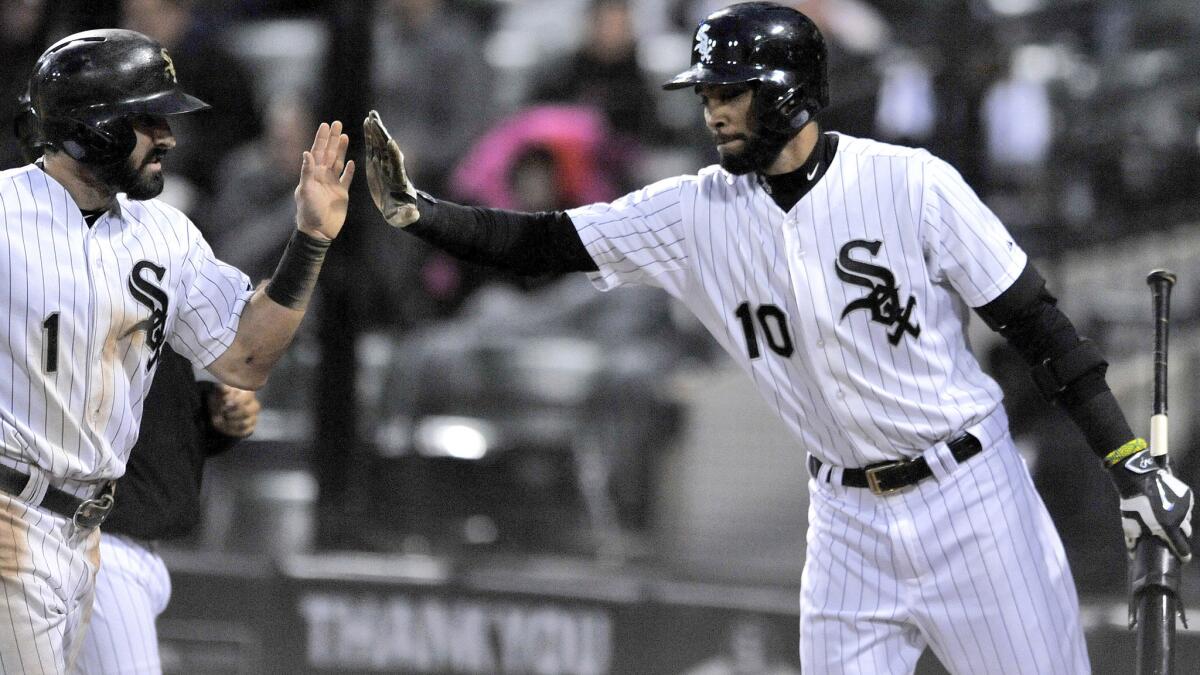 Alexei Ramirez (10) congratulates White Sox teammate Adam Eaton (1) after he scored during a game against the Tigers on Oct. 3, 2015.