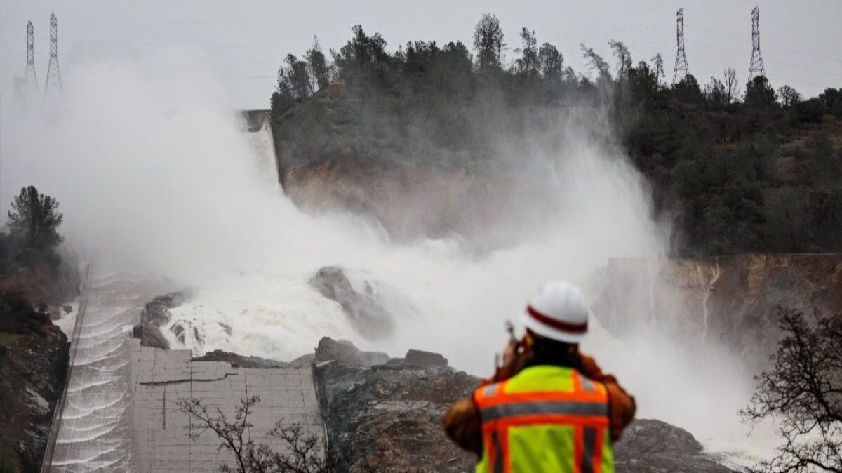 Work crews were scrambling Sunday to shore up the damaged spillways at the Oroville Dam as another big storm moves into the area.