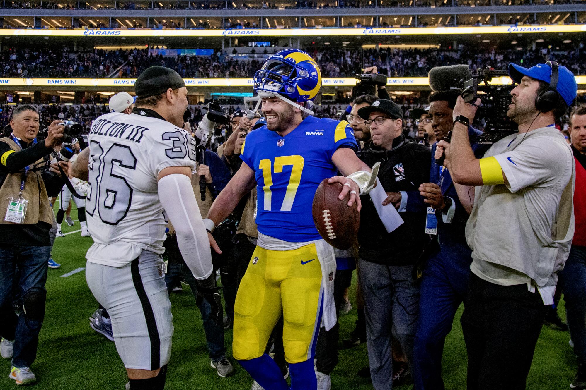Rams quarterback Baker Mayfield is congratulated by Las Vegas Raiders linebacker Curtis Bolton.
