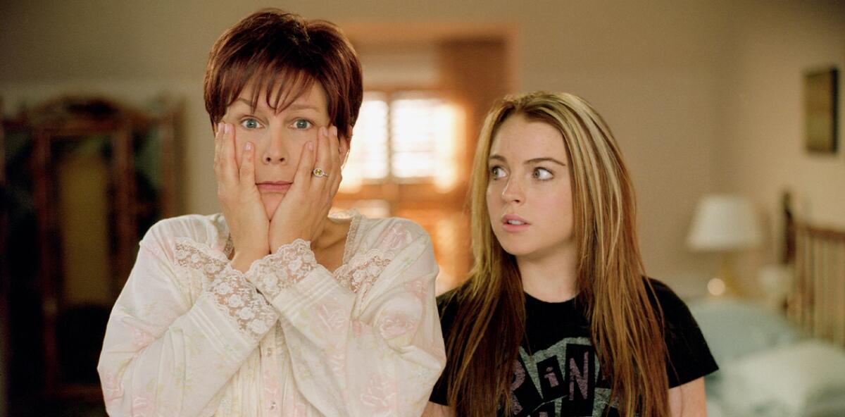 A woman wears a shocked expression with a teenage girl standing next to her looking at her