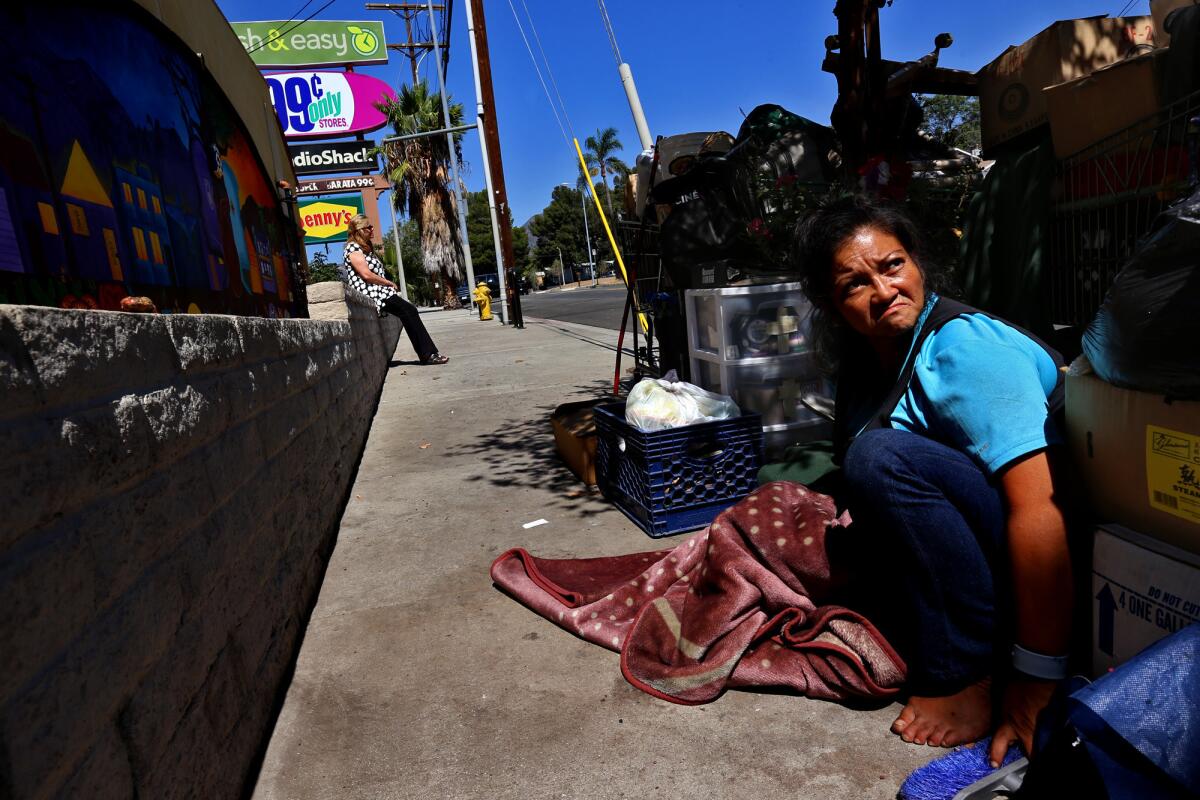 Since security has recently started patrolling the Sylmar shopping center, Cecilia and her husband (not pictured) have moved their belongings to a nearby sidewalk in Sylmar.