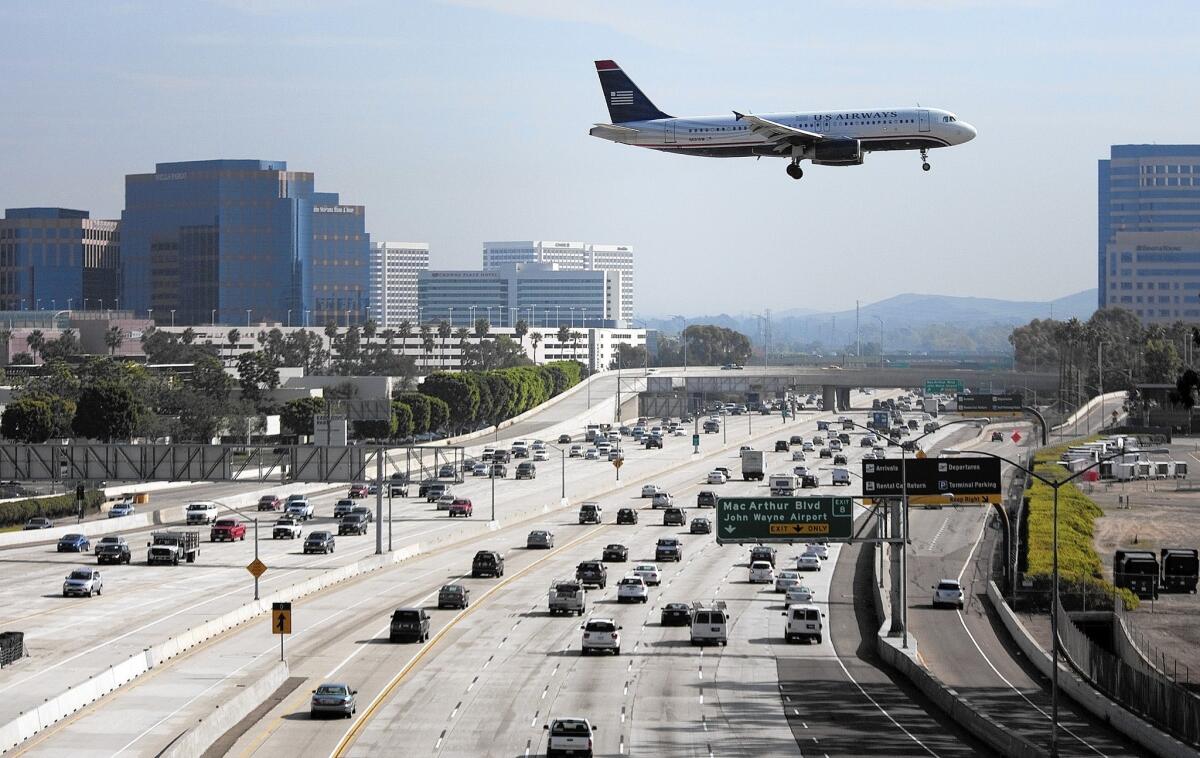 A jet flies over the 405 Freeway on its approach to John Wayne Airport in Orange County.