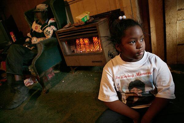 Ledosha Lott, 7, in Baptist Town, Miss., wears a T-shirt with a picture of her grandmother, who died last year because of diabetes and other health problems. Mississippi ranks at or near the bottom of most healthcare indexes.