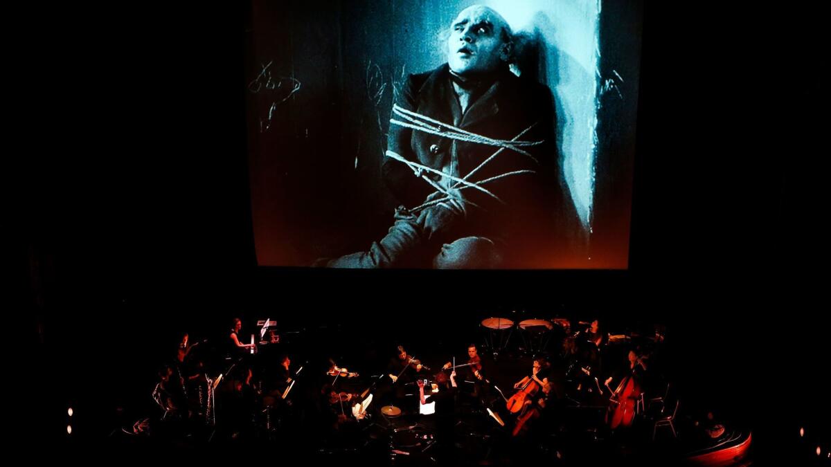 Members of the L.A. Opera Orchestra rehearse for the Saturday presentation of "Nosferatu" at the Theatre at Ace Hotel in Los Angeles. The program repeats on Halloween.