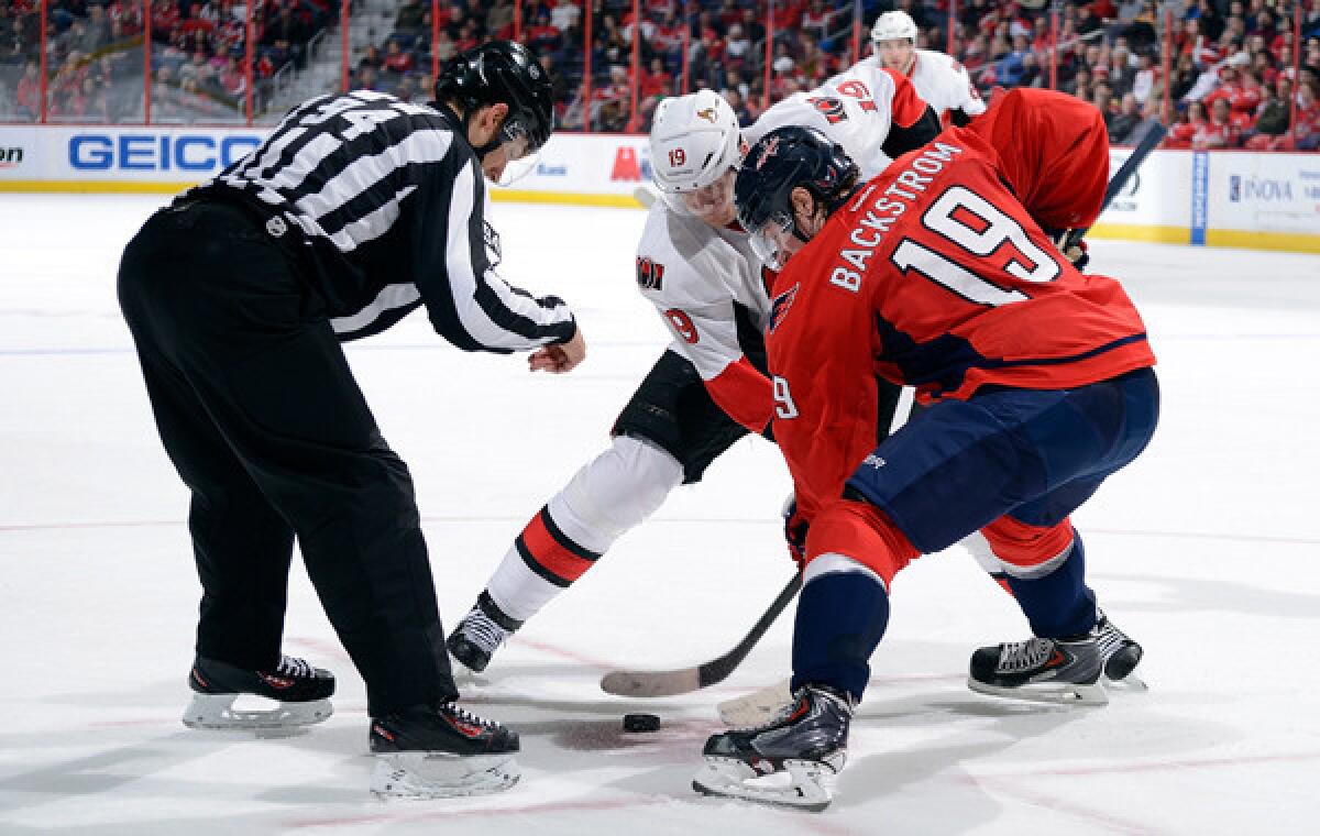 Ottawa Senators center Jason Spezza, center, and Washington Capitals center Nicklas Backstrom face off during a Jan. 21 game. NHL general managers have agreed to recommend changes regarding faceoffs to the league's competition committee.