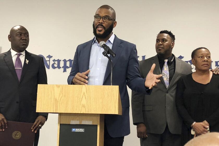 Filmmaker Tyler Perry, center, speaks to a a press conference announcing a lawsuit against former Collier County Sheriff's Deputy Steven Calkins, Monday, Sept. 4, 2018 in Naples, Fla. Perry and attorney Benjamin Crump, left, filed a lawsuit on the 2004 disappearance of Terrance Williams, who vanished after Calkins arrested him. Attorney Chris O'Neal and WIlliams' mother, Marcia Williams are on the right.
