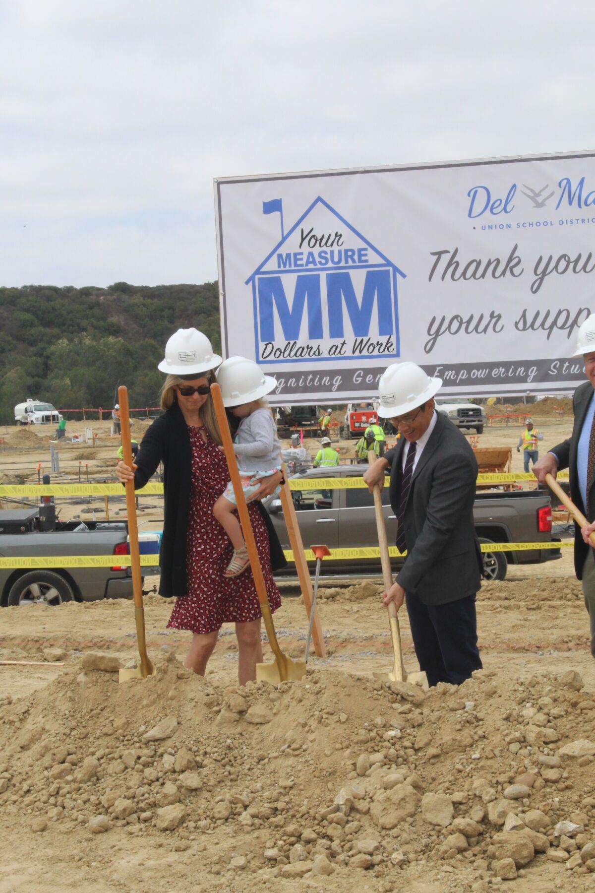 DMUSD board member Katherine Fitzpatrick and Clerk Gee Wah Mok help start the dig.