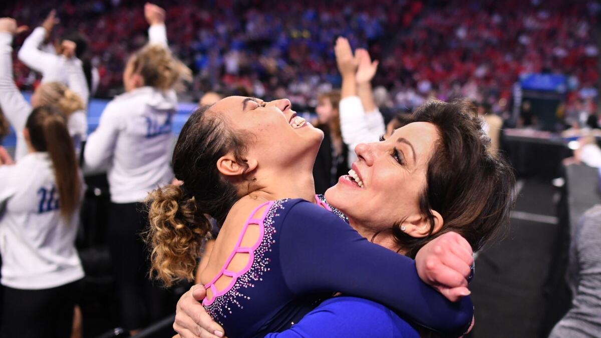 Katelyn Ohashi jumps into the arms of coach Valorie Kondos Field after her perfect score on the floor exercise during the Pac-12 championship in Utah.