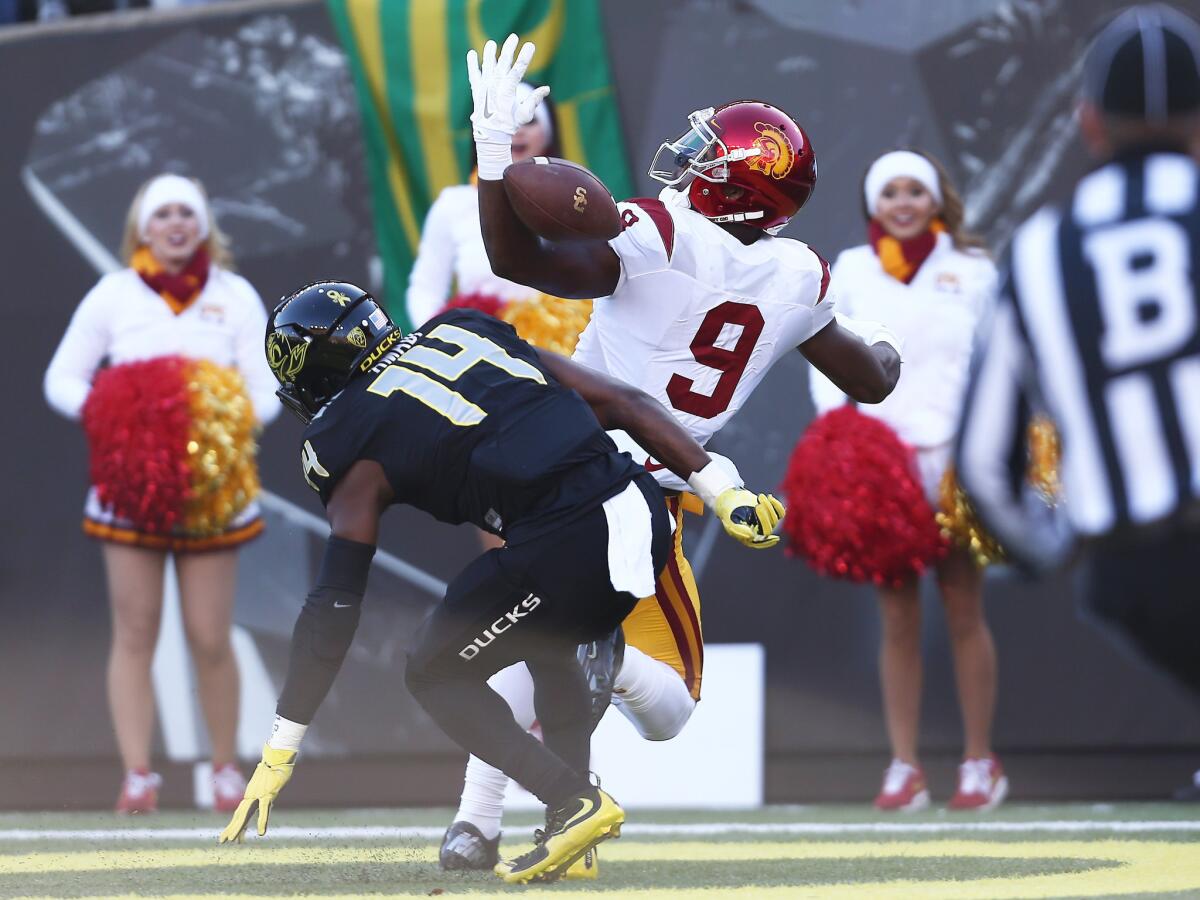 Oregon cornerback Ugo Amadi (14) breaks up a pass intended for USC wide receiver JuJu Smith-Schuster (9) in the first half.