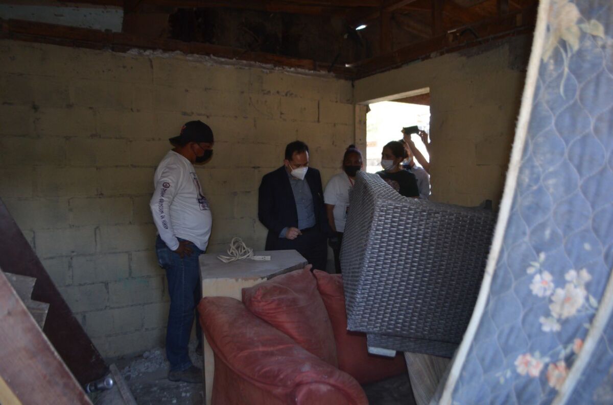 State prosecutor Hiram Sanchez, center, tours a property in Tijuana where parents found remains of at least a dozen people. 
