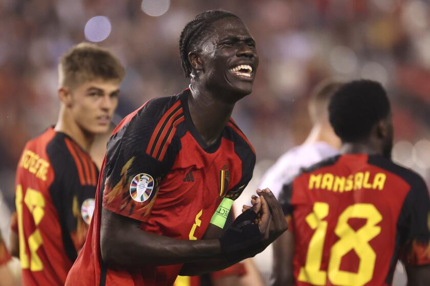 FILE - Belgium's Amadou Onana, center, reacts during the Euro 2024 group F qualifying soccer match between Belgium and Estonia in Brussels, Belgium, Tuesday, Sept. 12, 2023. For all its talent, Belgium's so-called golden generation of soccer players has never won a major title. With only a few members of that era still around, a new group of ambitious youngsters chaperoned by seasoned veterans will compete at the European Championship, looking to shed the country's underachiever reputation. (AP Photo/Geert Vanden Wijngaert, File)