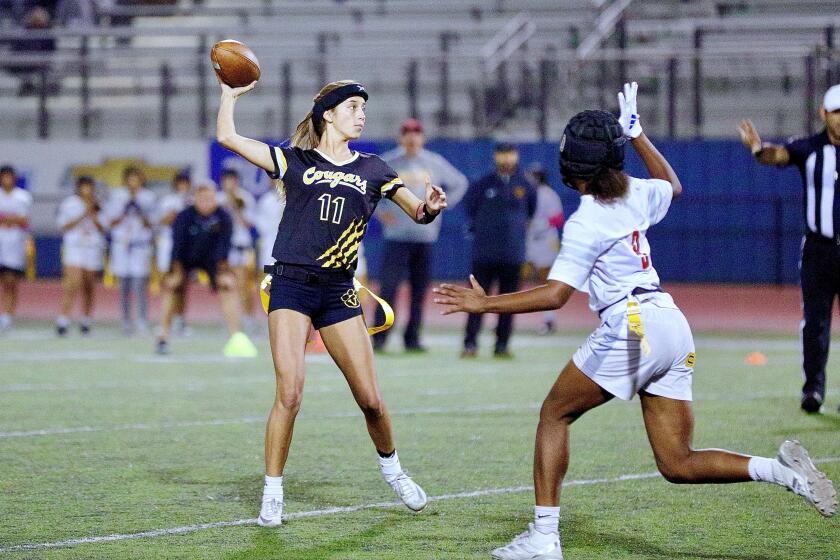 Ventura flag football quarterback Ava Ortman leans back to throw a pass during a game.