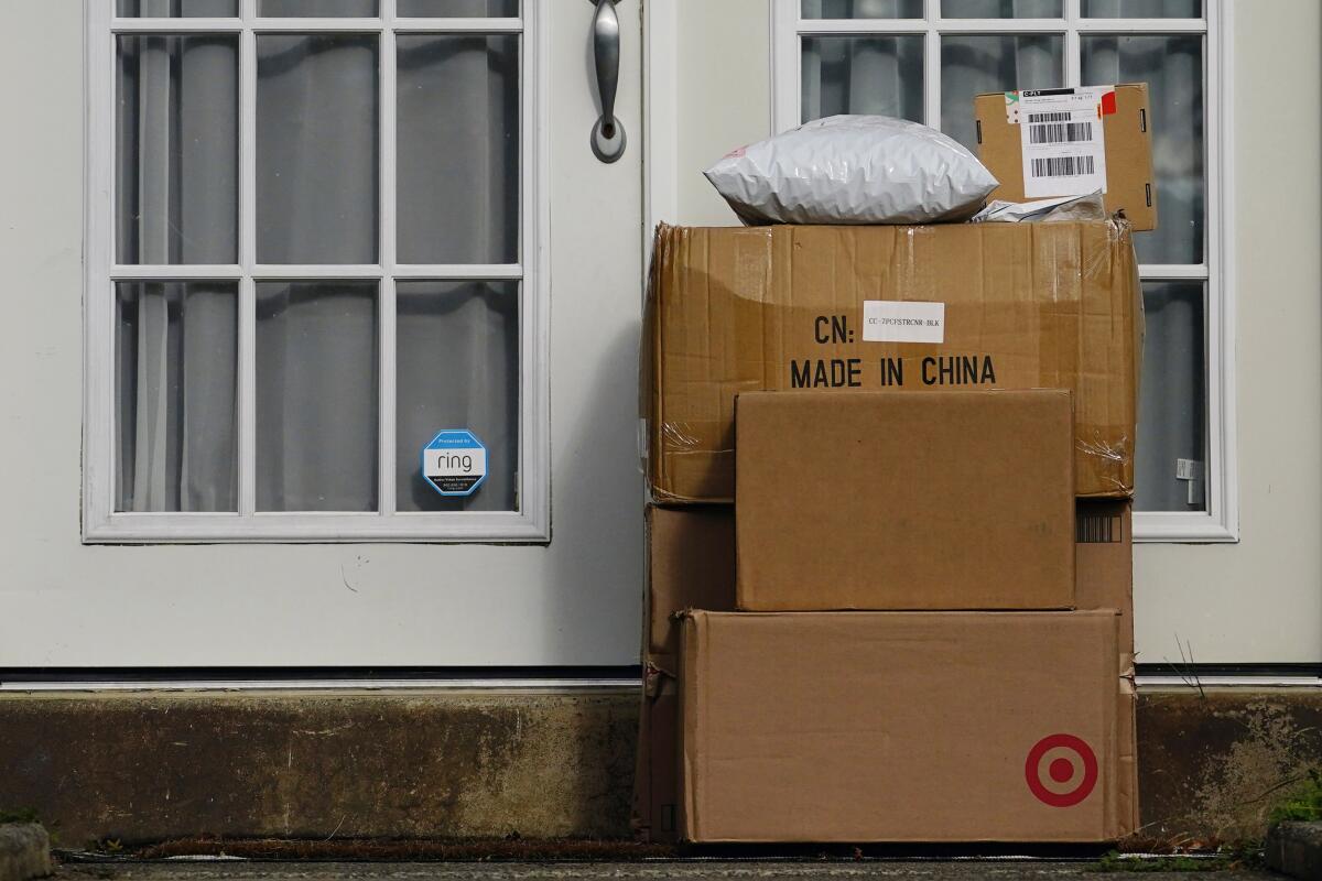 Packages stacked on the doorstep of a home 