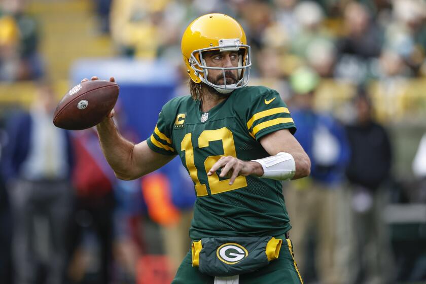 Green Bay Packers quarterback Aaron Rodgers (12) looks to pass the ball during the first half of an NFL football game against the Washington Football Team, Sunday, Oct. 24, 2021, in Green Bay, Wis. (AP Photo/Kamil Krzaczynski)