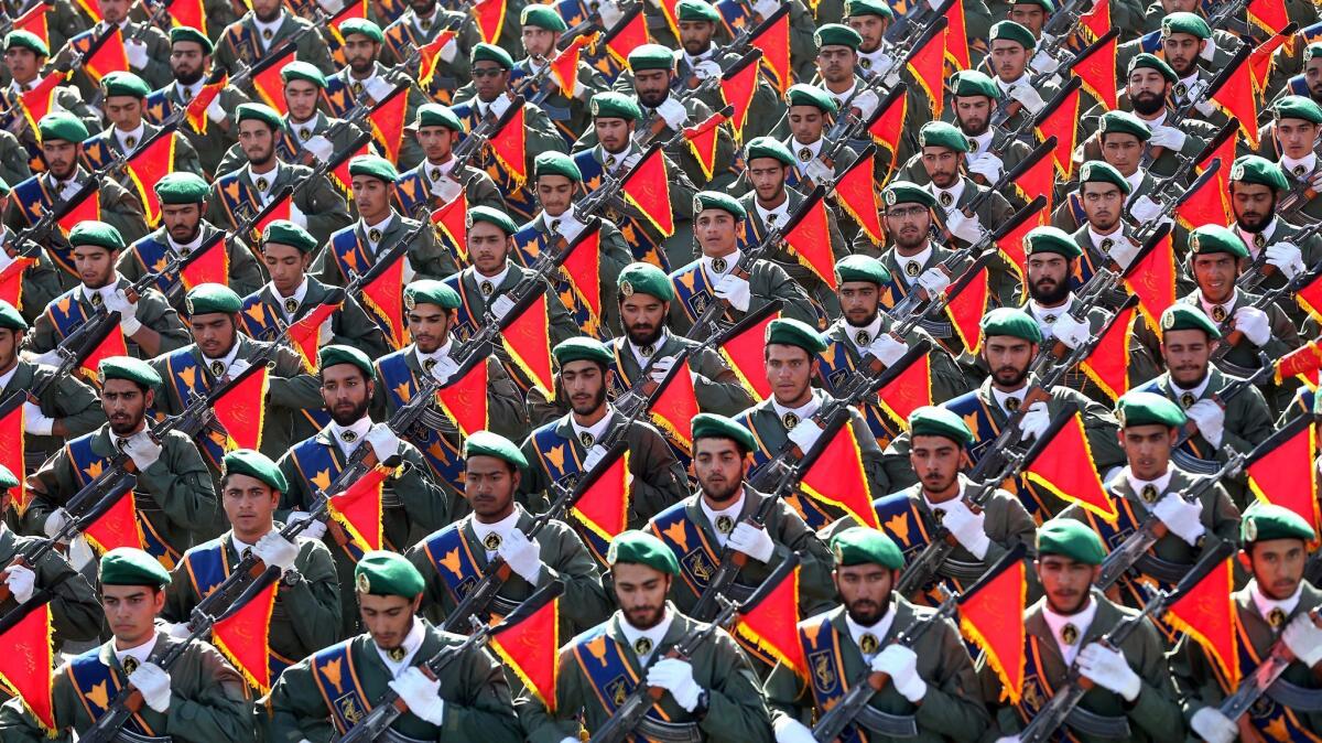 Members of Iran’s Islamic Revolutionary Guard march in a military parade outside Tehran in 2016. The Saudi-Iranian dispute is at the heart of regional conflicts in the Mideast.