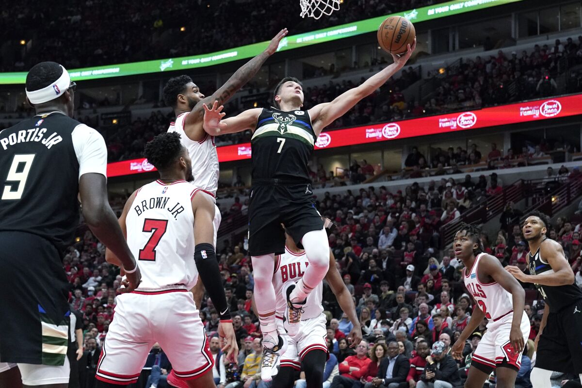 The Bucks' Grayson Allen (22 points) drives to the basket past the Bulls' Coby White during Game 3.