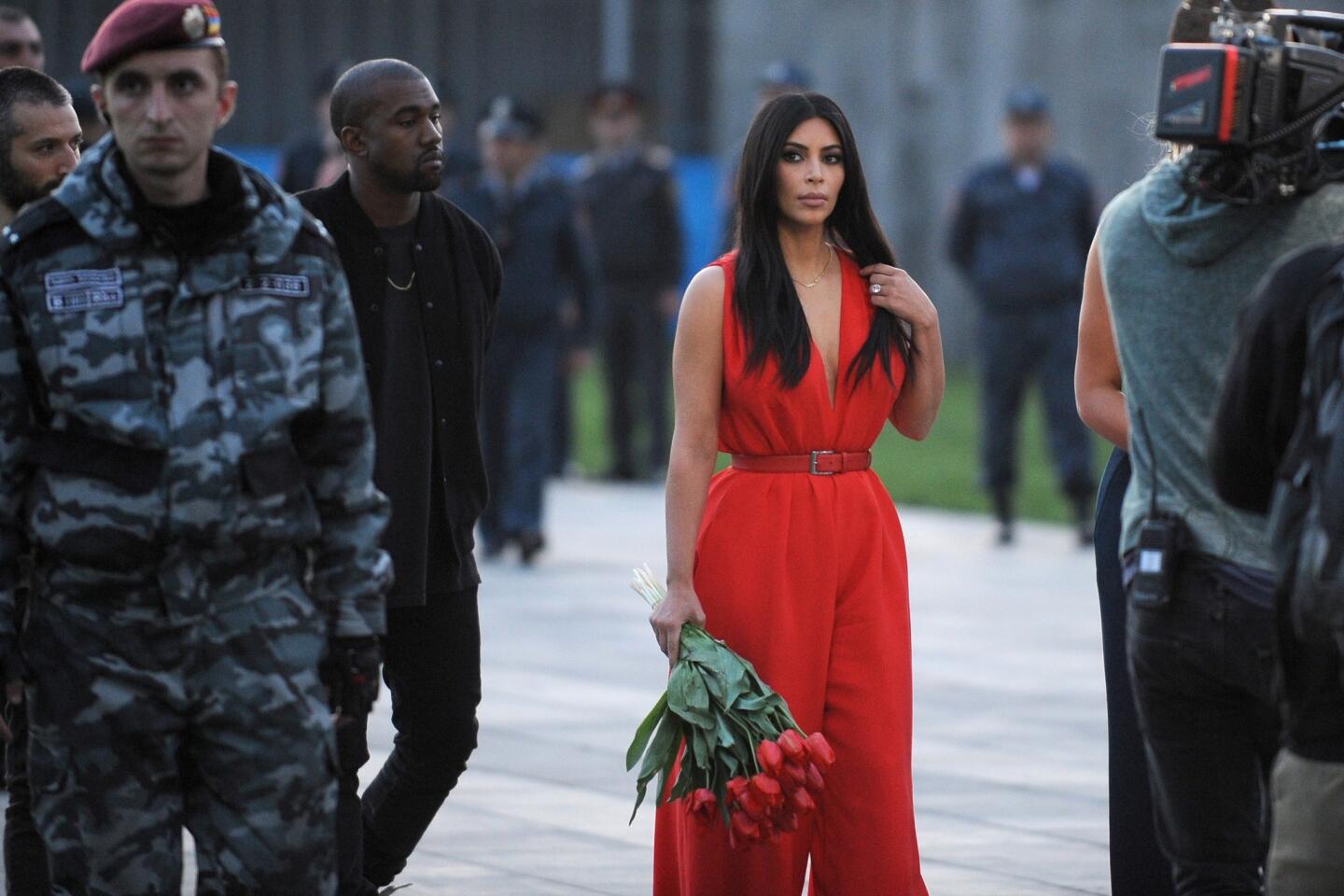 Reality TV star Kim Kardashian (C) and her rapper husband Kanye West (3rdL) visit the genocide memorial, which commemorates the 1915 mass killing of Armenians in the Ottoman Empire, in Yerevan