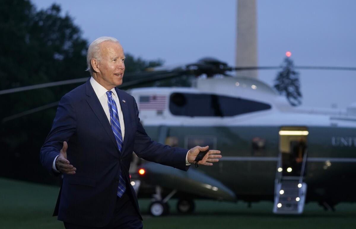 President Joe Biden talks with reporters after returning to the White House in Washington, Tuesday, Oct. 5, 2021, after a trip to Michigan to promote his infrastructure plan. (AP Photo/Susan Walsh)