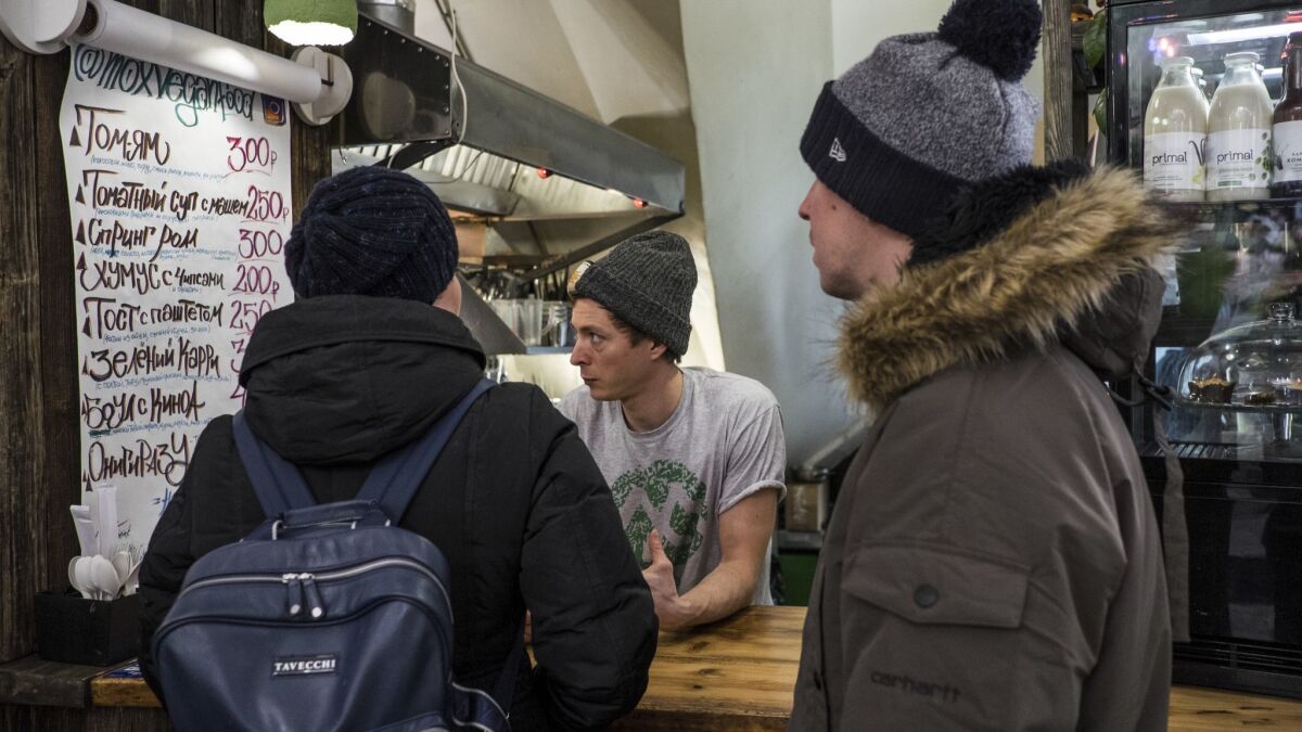 Karibu Kombucha founder Ilya Devedzhian talks with some of his customers at Danilovsky Market in Moscow.