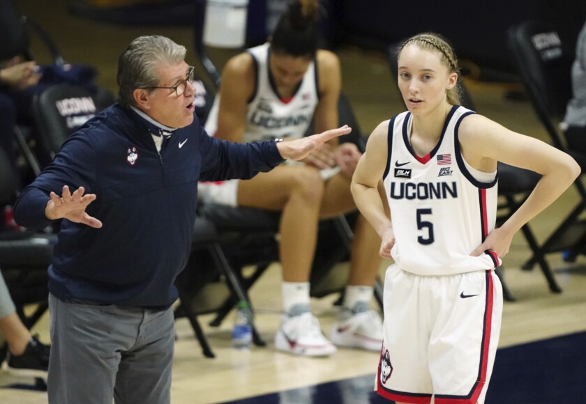 Connecticut head coach Geno Auriemma, left, talks with guard Paige Bueckers (5) during a break in the first quarter against Marquette during an NCAA college basketball game Monday, March 1, 2021, in Storrs, Conn. (David Butler II/Pool Photo via AP)