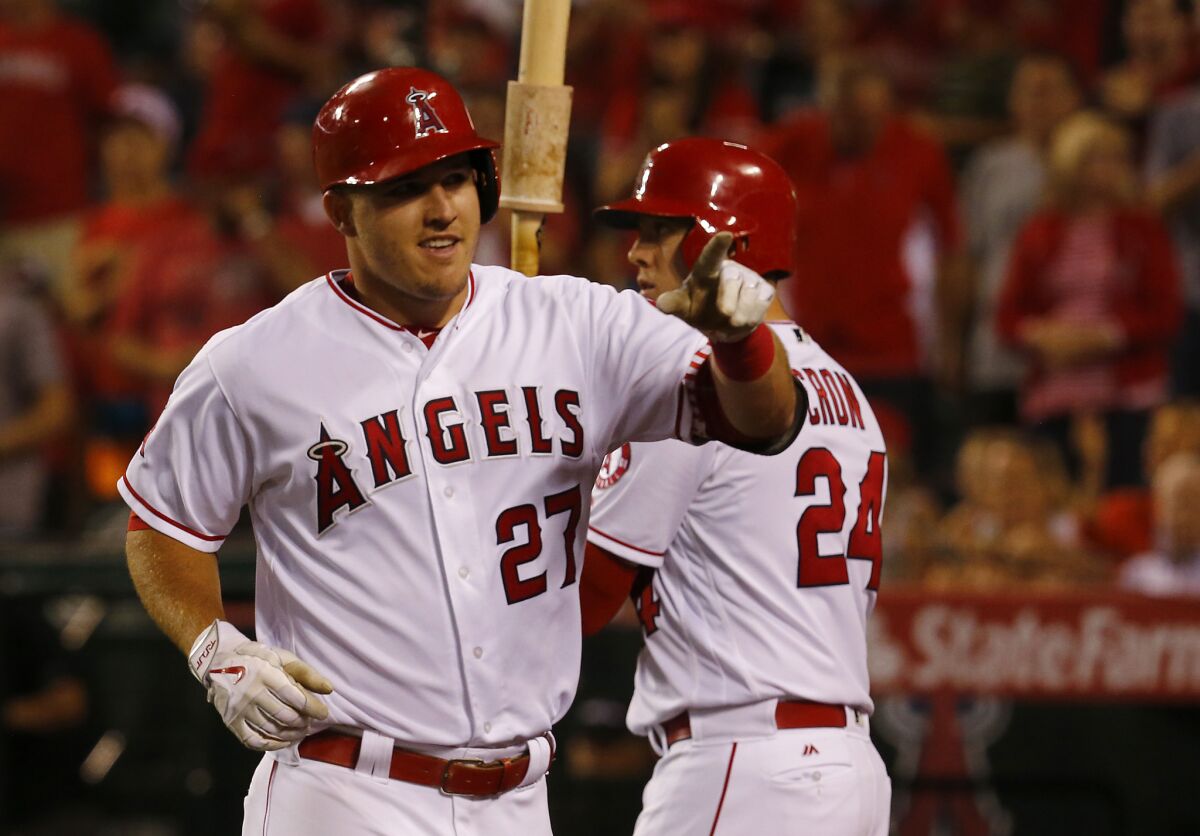 Angels center fielder Mike Trout celebrates after hitting a solo home run against the Astros on June 27 at Angels Stadium.