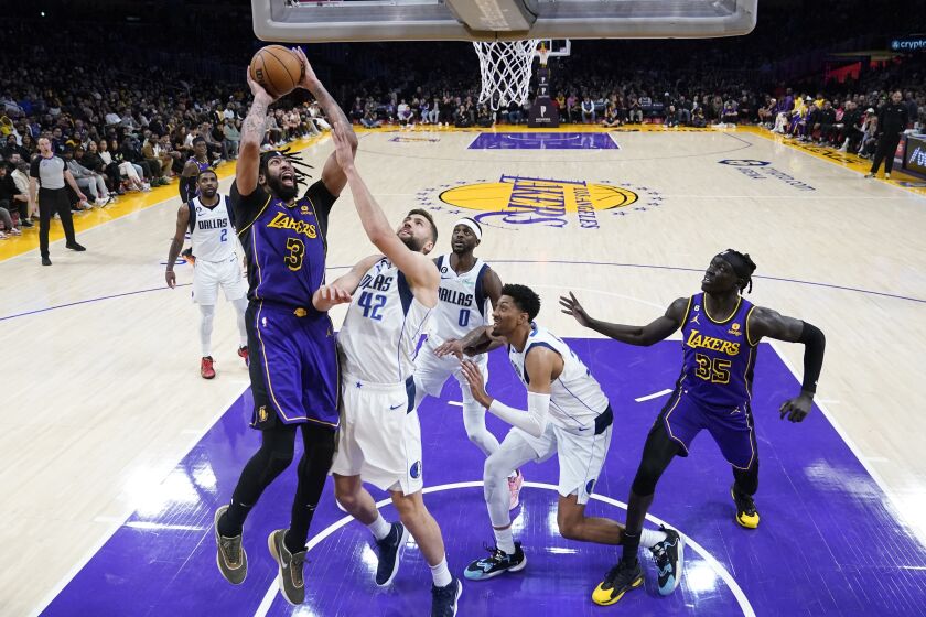 Los Angeles Lakers forward Anthony Davis (3) shoots over Dallas Mavericks forward Maxi Kleber (42) during the second half of an NBA basketball game Friday, March 17, 2023, in Los Angeles. (AP Photo/Marcio Jose Sanchez)