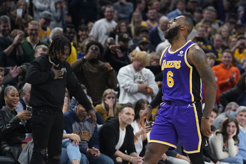 Los Angeles Lakers' LeBron James reacts after hitting a shot during overtime of in the team's NBA basketball game against the Indiana Pacers, Wednesday, Nov. 24, 2021, in Indianapolis. (AP Photo/Darron Cummings)