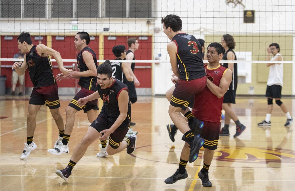 Estancia High celebrates after coming back from two sets down to upset Costa Mesa in Thursday's Orange Coast League match at home.