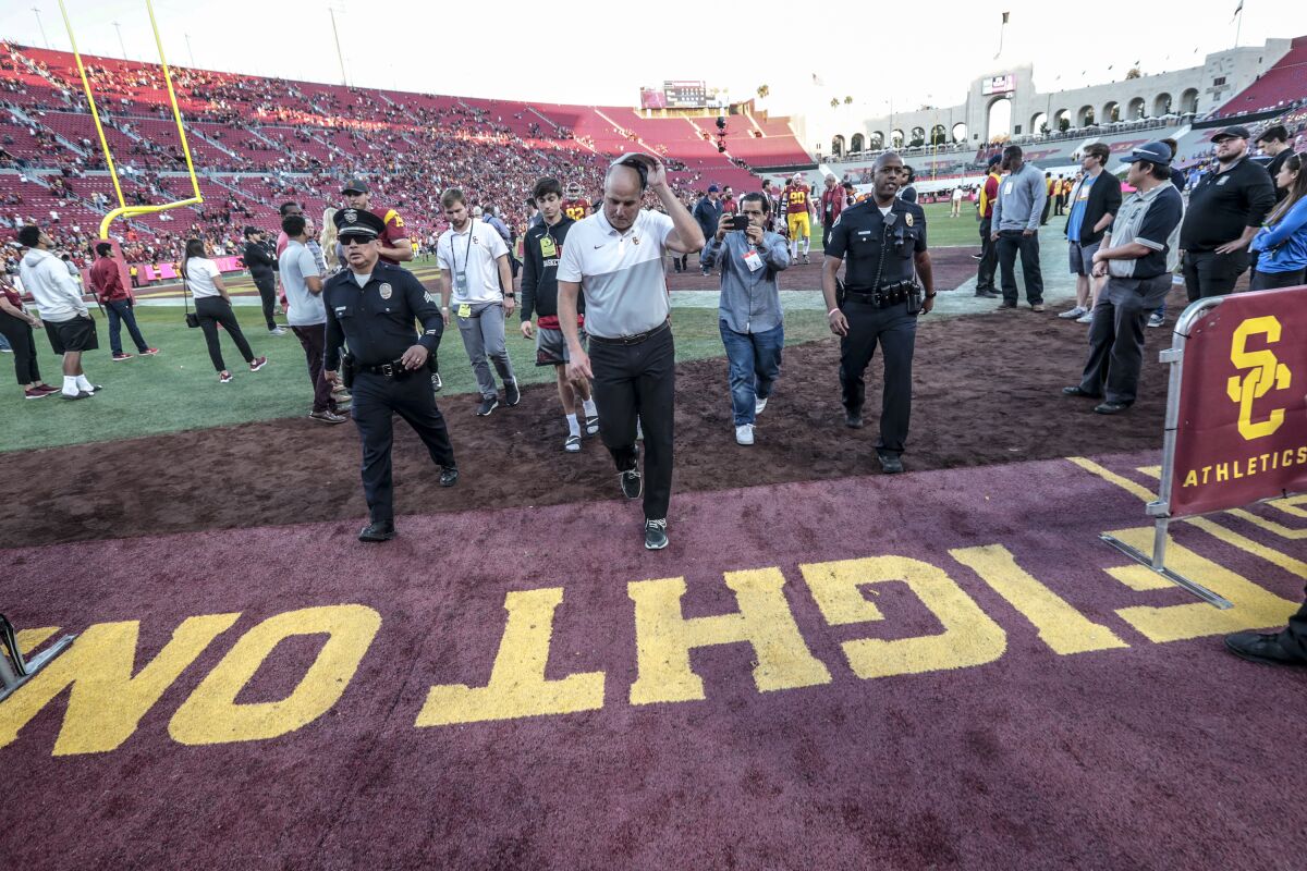 USC coach Clay Helton leaves the field after the Trojans beat UCLA on Nov. 23 at the Coliseum.