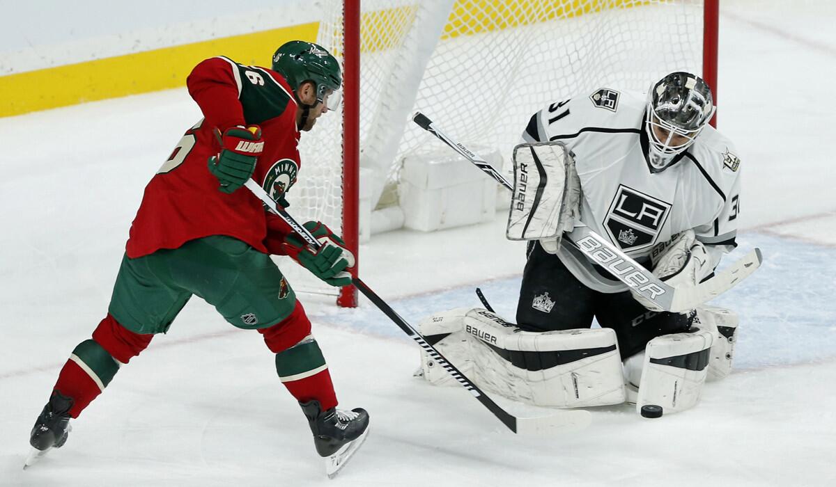Kings goalie Peter Budaj, right, stops a shot by Minnesota Wild's Jason Zucker during the third period Tuesday.