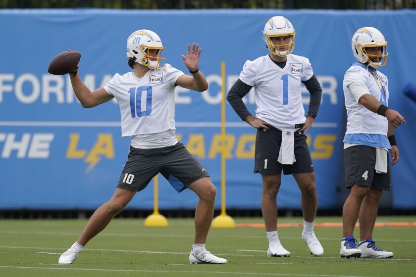 Los Angeles Chargers quarterback Justin Herbert (10) participates in drills during an NFL football practice at the Chargers practice facility in Costa Mesa, Calif., Monday, May 23, 2022. (AP Photo/Ashley Landis)