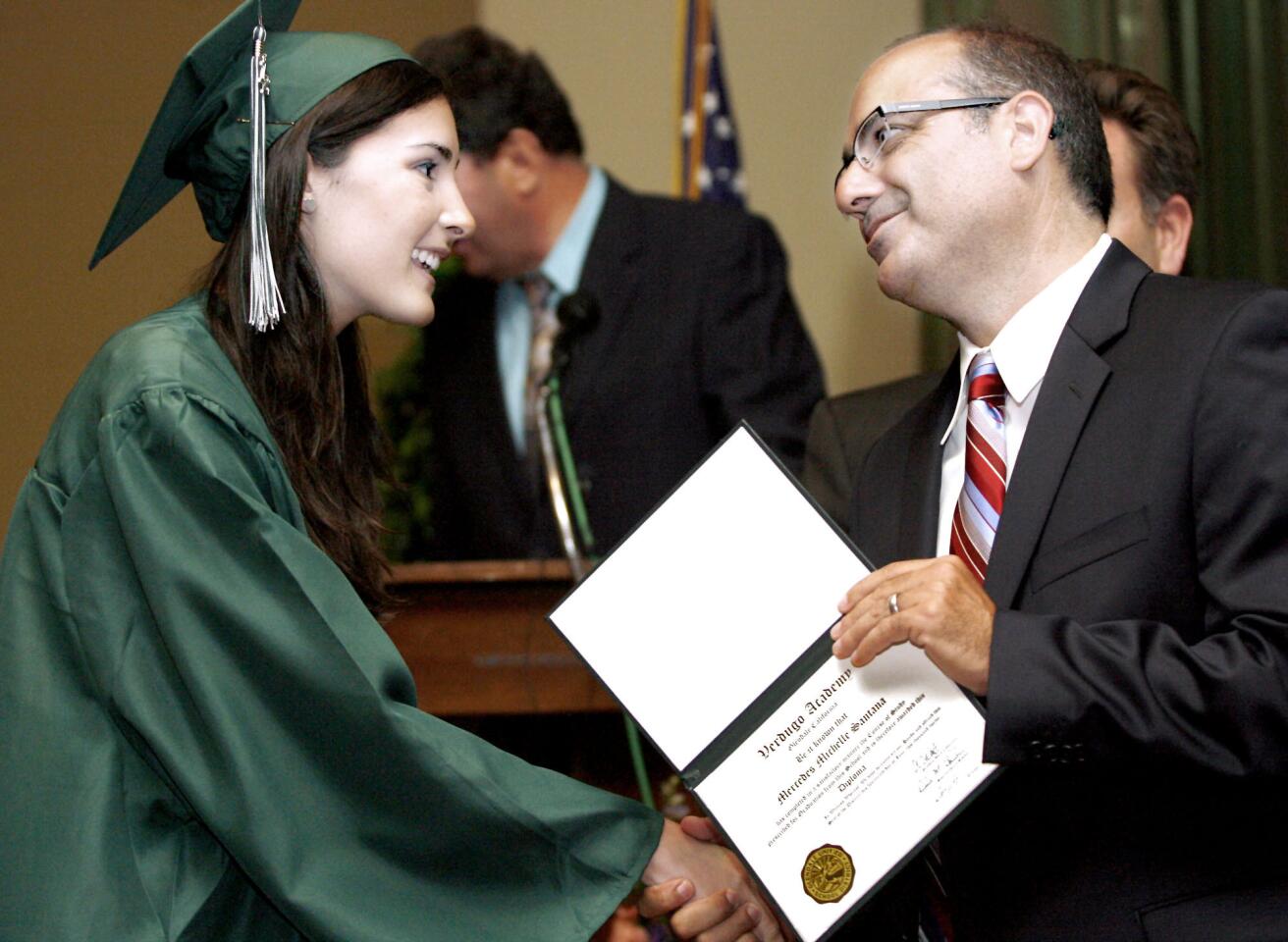 Mercedes Santana, 18 of Huntington Beach, left, gets her diploma from GUSD board member Greg Krikorian at the Verdugo Academy graduation at the First United Methodist Church Carlson Fellowship Hall in Glendale on Thursday, June 14, 2012. Glendale Unified School District's Daily HS, Re-Connected Glendale and Verdugo Academy held the commencement exercises at the same time and location.