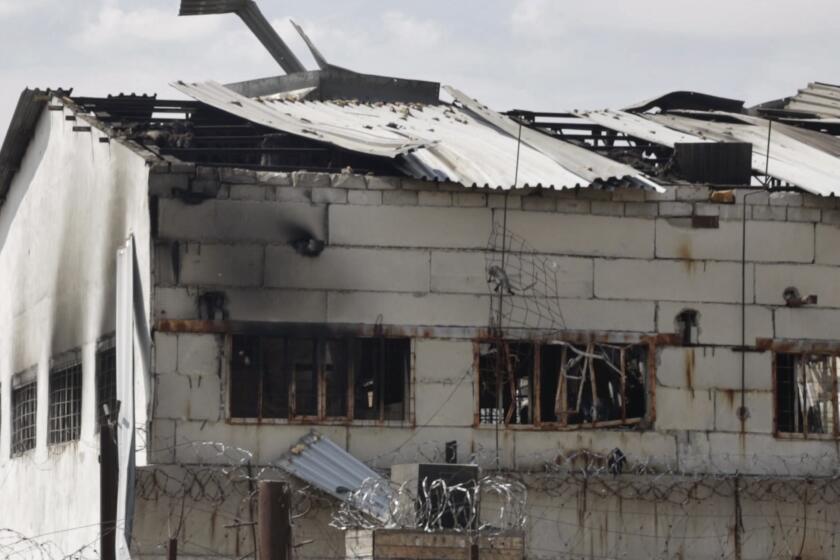 In this photo taken from video a view of a destroyed barrack at a prison in Olenivka, in an area controlled by Russian-backed separatist forces, eastern Ukraine, Friday, July 29, 2022. Russia and Ukraine accused each other Friday of shelling a prison in a separatist region of eastern Ukraine, an attack that reportedly killed dozens of Ukrainian military prisoners who were captured after the fall of a southern port city of Mariupol in May. (AP Photo)
